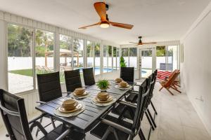 Vero Beach Vacation Rental Pool and Putting Green! في فيرو بيتش: غرفة طعام مع طاولة وكراسي