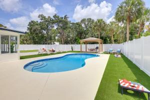 a swimming pool in the backyard of a house at Vero Beach Vacation Rental Pool and Putting Green! in Vero Beach