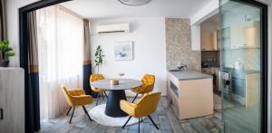 a kitchen and dining room with a table and chairs at A&K COZY ART Studio 2 in Varna City