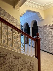 a staircase in a house with ornate wallpaper at Sfiha/Hoceima huis in Al Hoceïma