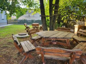 a wooden picnic table and chairs in a yard at Apartamenty Premium Biznes Rumia in Rumia