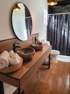 a bathroom with two sinks and a large mirror at VALLE LIFE in Sansoni