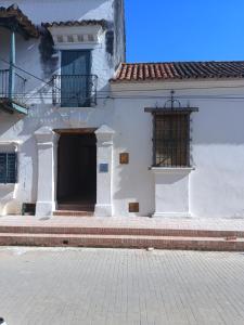 a white building with a door and a window at Hotel Boutique Casa Gerar in Mompos