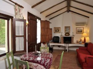 a living room with a table and a fireplace at Monte dos Pensamentos - Turismo Rural in Estremoz