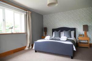 a bedroom with a large bed and a window at Stunning lodge in idyllic rural Herefordshire in Dorstone