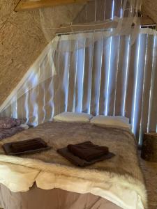 a bed with white sheets and towels on it at Karula Stay Sauna House in Karula National Park in Ähijärve