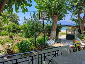 a basketball hoop in a garden with a tree at Asmini Beach Apartments in Asmínion