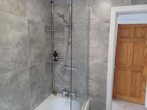 a bathroom with a shower with a glass door at 46 Linden Road in Scalby