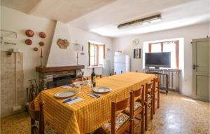 una sala da pranzo con tavolo, sedie e TV di Pet Friendly Home In Bergotto With Outdoor Swimming Pool a Roccaprebalza