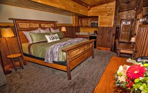 a bedroom with a bed and a table in a room at The Lodges at Cresthaven in Lake George