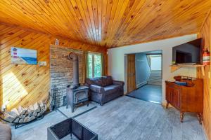 a living room with a couch and a stove at Cozy Livingston Manor Home with Wood-Burning Stove! in Livingston Manor