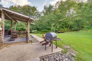 a grill in a yard next to a gazebo at Cozy Livingston Manor Home with Wood-Burning Stove! in Livingston Manor