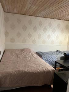 a bedroom with two beds and a wall at Accommodation in Billund