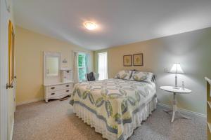 a bedroom with a bed and a table and a mirror at Cozy Langley Retreat Water Views and Beach Access in Langley