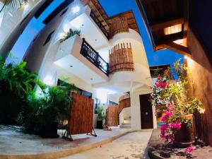 a lobby of a building with flowers and plants at Boutique Condo Close to Everything in Zihuatanejo