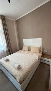 a bedroom with a large bed with two pillows at Luxury Apart Vitosha Boulevard in Sofia