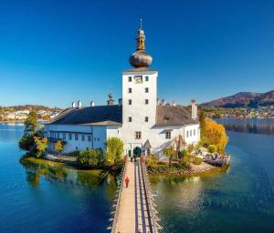 a large white church on an island in the water at Holiday apartment in Gmunden 