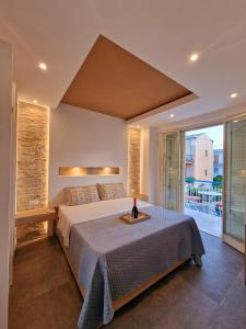 a bedroom with a large bed and a balcony at Mongibello Palace B&B in Mondello