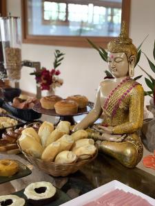 a statue of a woman sitting on a table with bread at Embaúba Boutique Hotel in Teresópolis