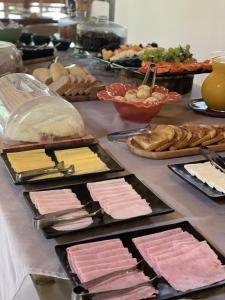 a table topped with lots of different types of food at Embaúba Boutique Hotel in Teresópolis