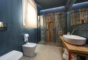 een badkamer met een wastafel, een toilet en een douche bij IL MARE DENTRO SUITES in San Vito lo Capo