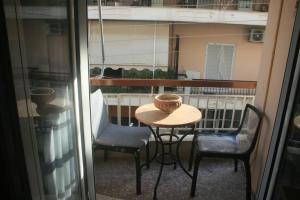 a table with two chairs and a bowl on a balcony at Billy's appartment in Preveza