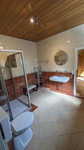 a bathroom with a toilet and a sink at FeWo Sonnenschein Bungalow in Sankt Ingbert