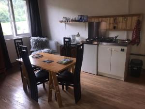 a kitchen with a wooden table and a table and chairs at Le refuge du berger in Choux