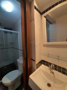 a bathroom with a toilet and a sink and a mirror at Albergue Rio Vermelho in Salvador +68 photos