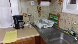 a kitchen counter with a sink and a mixer and a kitchen counter at Nicolas Dream in Nea Makri