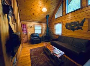 a living room with a couch and a fireplace at The Loft at Bear Mountain log cabins in Eureka Springs