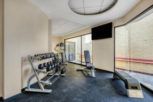 a gym with several tread machines and a large window at Fiesta Inn Oaxaca in Oaxaca City