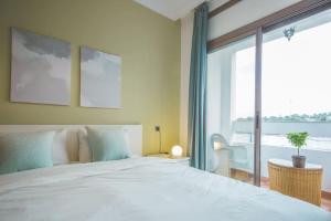 a bedroom with a large bed and a large window at lovely 2 bedroom vacation home with pool/beach in Skhirat +17 photos