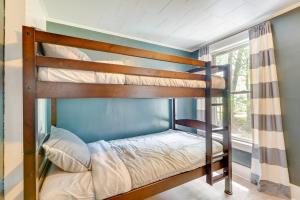 a bedroom with two bunk beds in a room at Outdoorsy Oasis with Screened Porch in Claremont in Claremont