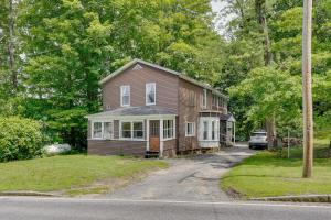 a brown house with a car parked in front of it at Outdoorsy Oasis with Screened Porch in Claremont in Claremont