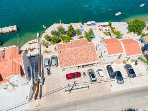 an overhead view of a building with cars parked next to the water at Apartments Edera in Tivat