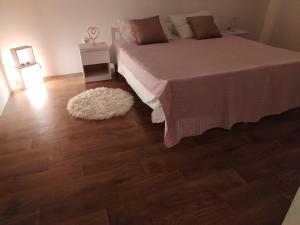a bedroom with a bed and a wooden floor at Ema in Prvić Šepurine