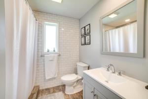 a bathroom with a sink and a toilet and a mirror at Deck and Patio Inviting Abode in Natrona Heights! in Natrona Heights +16 photos