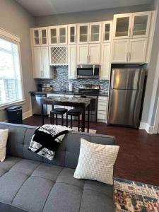 a living room with a couch and a kitchen at Luxury 1 Bedroom Apt in Plaza Midwood- Fast WiFi in Charlotte