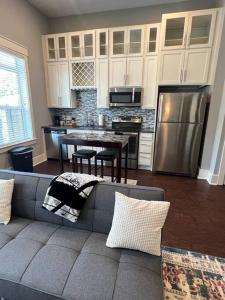 a living room with a couch and a kitchen at Luxury 1 Bedroom Apt in Plaza Midwood- Fast WiFi in Charlotte