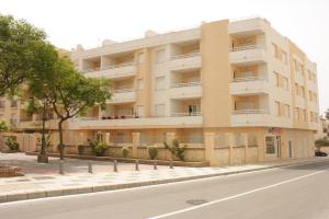 an apartment building on the side of a street at Apartamentos Turísticos Fercomar in Nerja