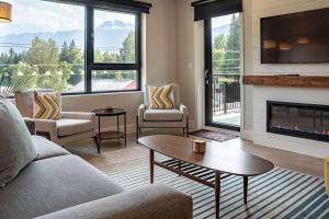 a living room with a couch and a fireplace at Northern Exposure by Revelstoke Vacations in Revelstoke