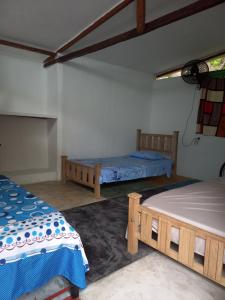 a room with two beds in a room at Eco-Cafe El Mirador in Guachaca