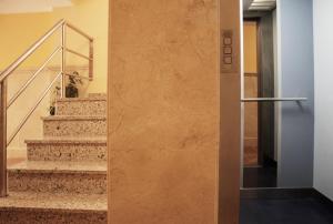 a dog sitting on the stairs of a building at Apartamentos Turísticos Fercomar in Nerja