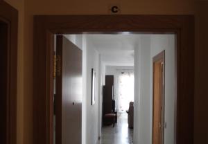 a hallway with a door open to a room at Apartamentos Turísticos Fercomar in Nerja