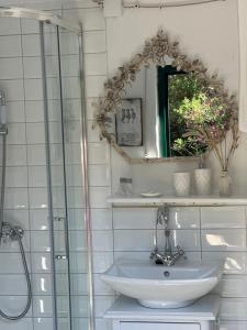 a bathroom with a sink and a mirror at Robinson house Leticia in Cunski