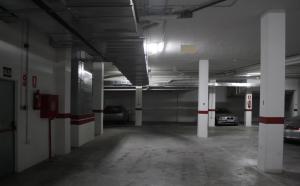 an empty parking garage with cars parked in it at Apartamentos Turísticos Fercomar in Nerja