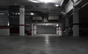 an empty parking garage with a car parked in it at Apartamentos Turísticos Fercomar in Nerja