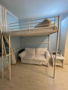 a bunk bed with a couch in a room at Hause münchen comfort! in Munich