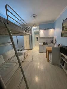 a bedroom with a bunk bed and a kitchen at Hause münchen comfort! in Munich